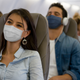 masked passengers in airplane